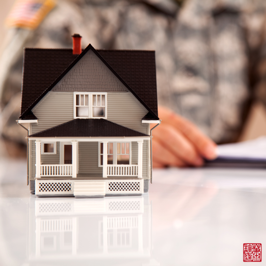 A silhouette of a military personnel and a miniature house representing veteran's benefits