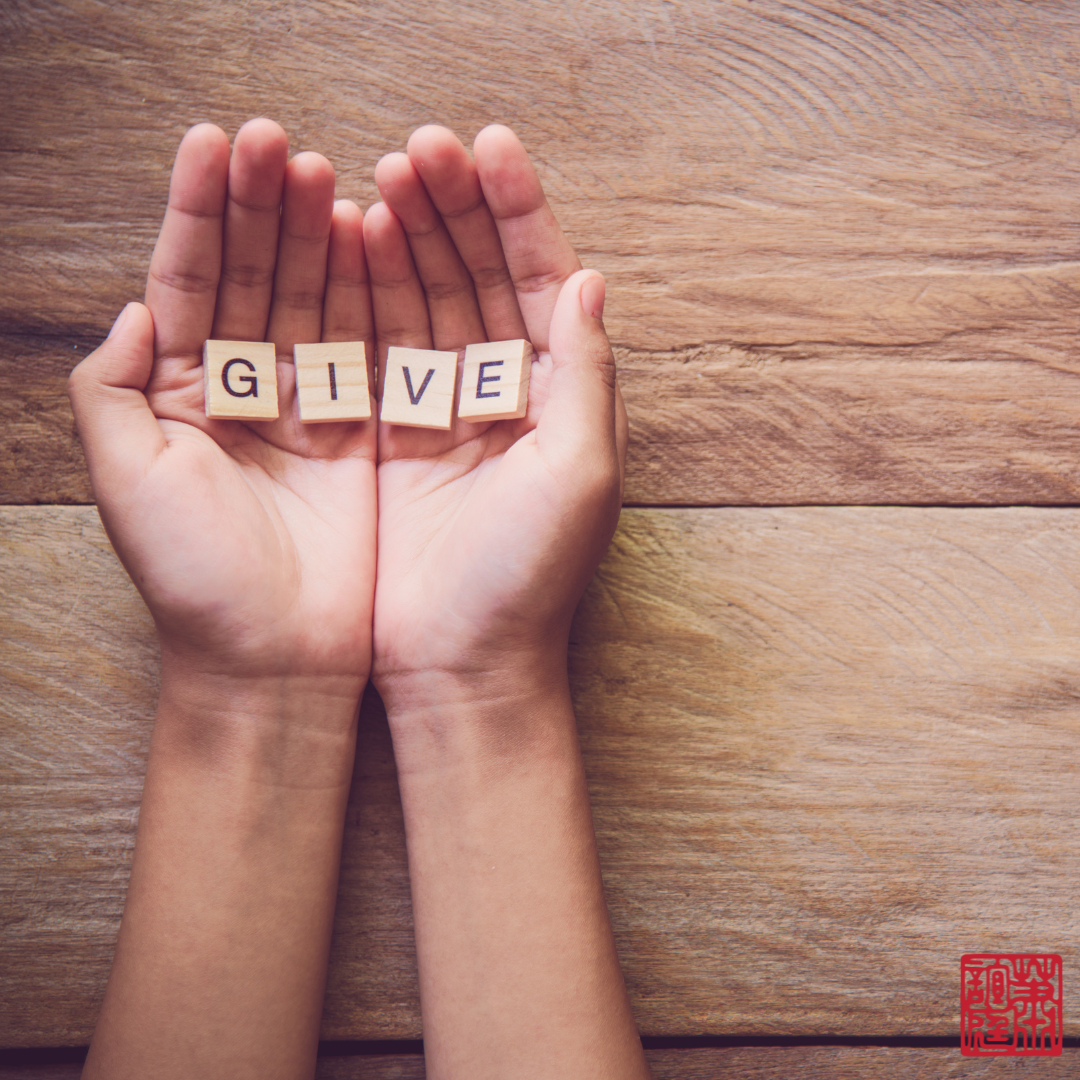 the words "give" resting on the palm