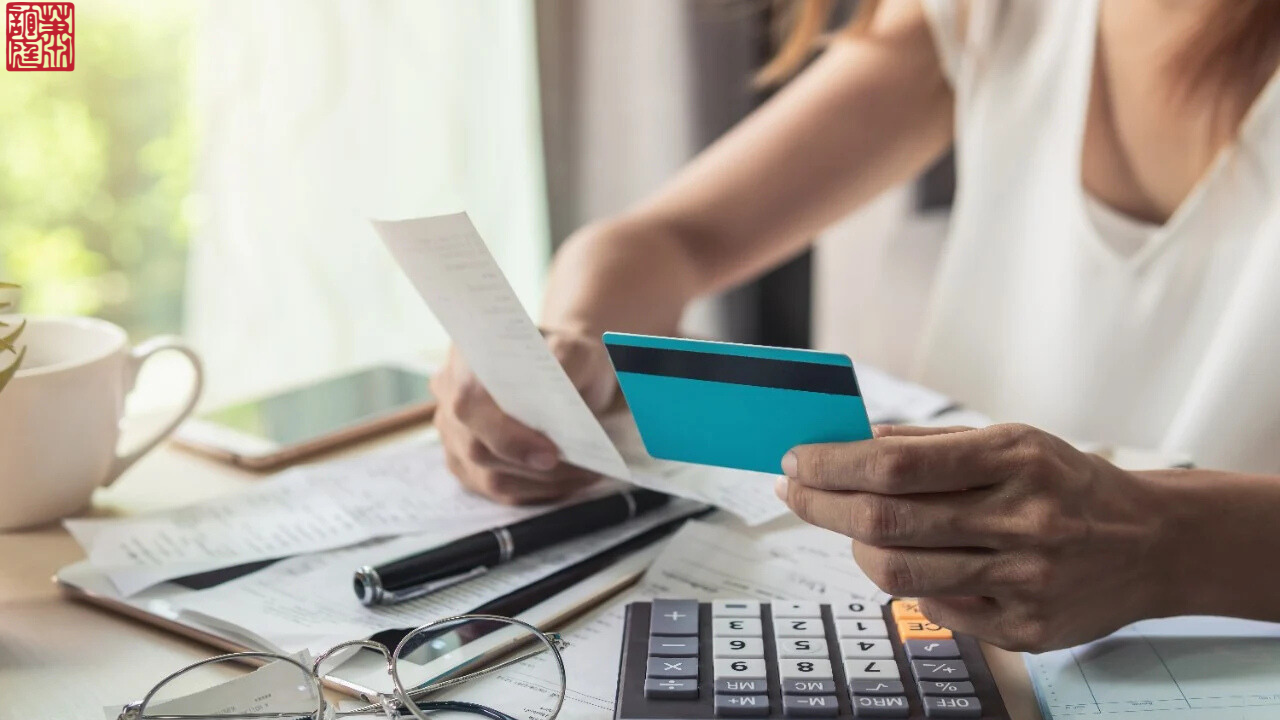 A Photo of a woman holding card and papers describes the title "Managing Debt After a Loved One's Death"