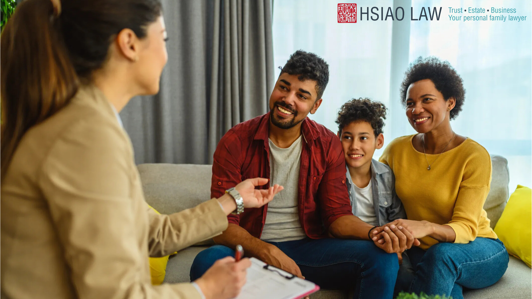 A photo of young family on the right and a lawyer /advisor on the left discussing an estate plan.