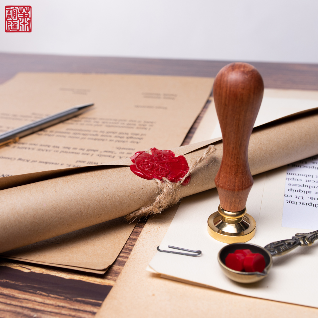 An image of a sealed document and a wax stamper sealing the inheritance document